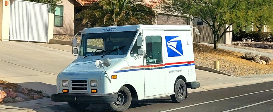 usps truck on the side of the street